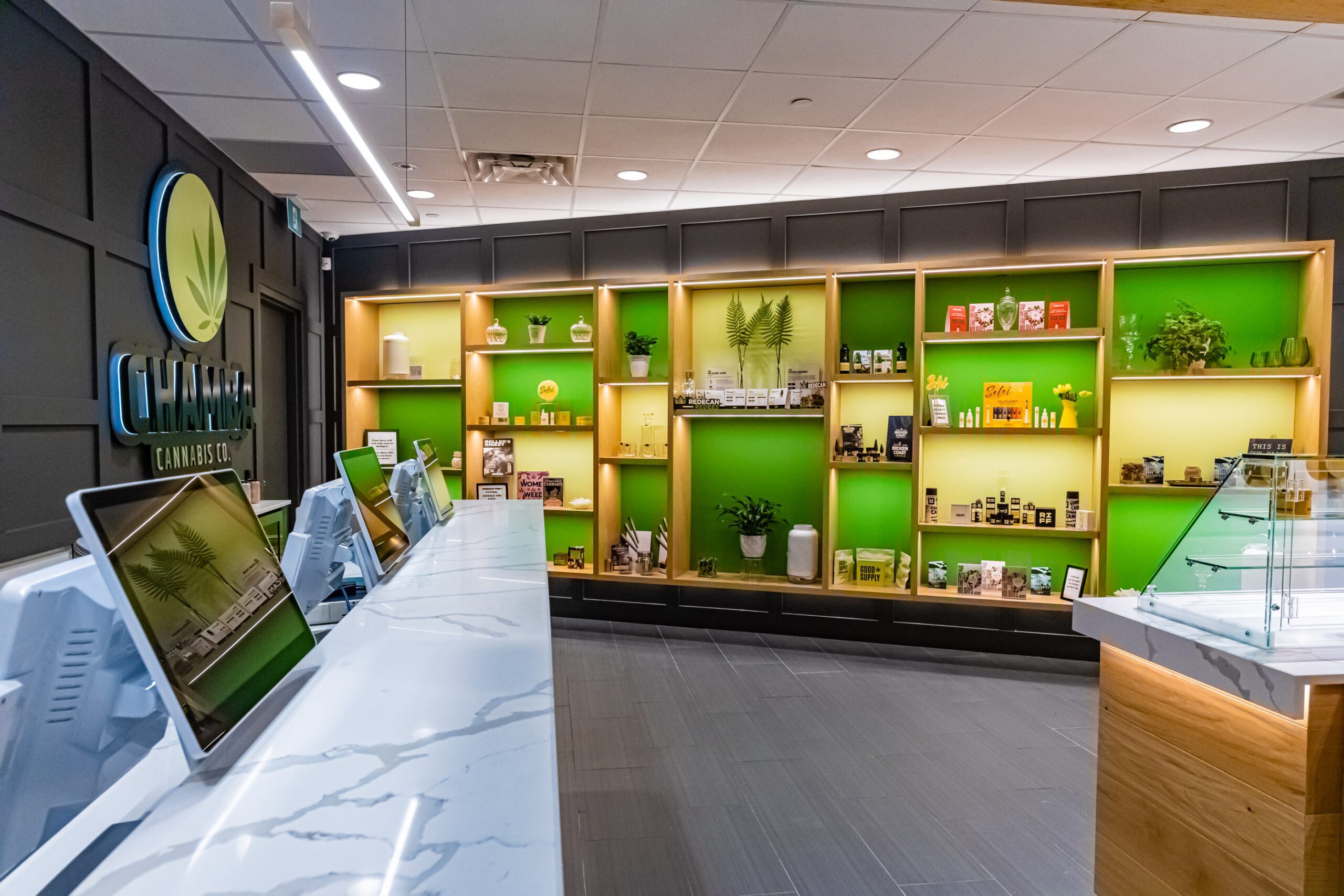Checkout area with digital screens and cannabis product displays at Chamba Cannabis Co. Waterloo store.