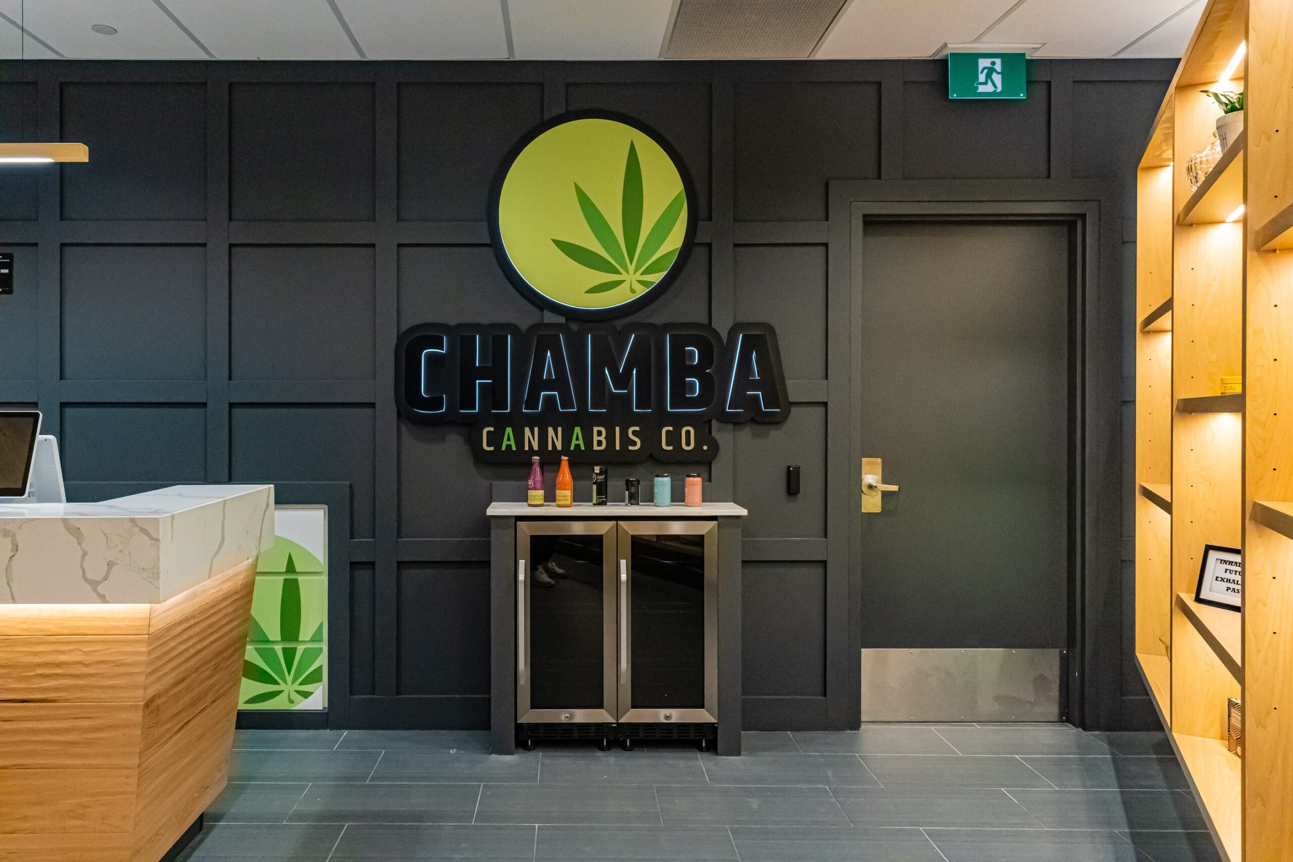 Back wall with Chamba Cannabis Co. logo and cannabis-infused beverages at Waterloo store