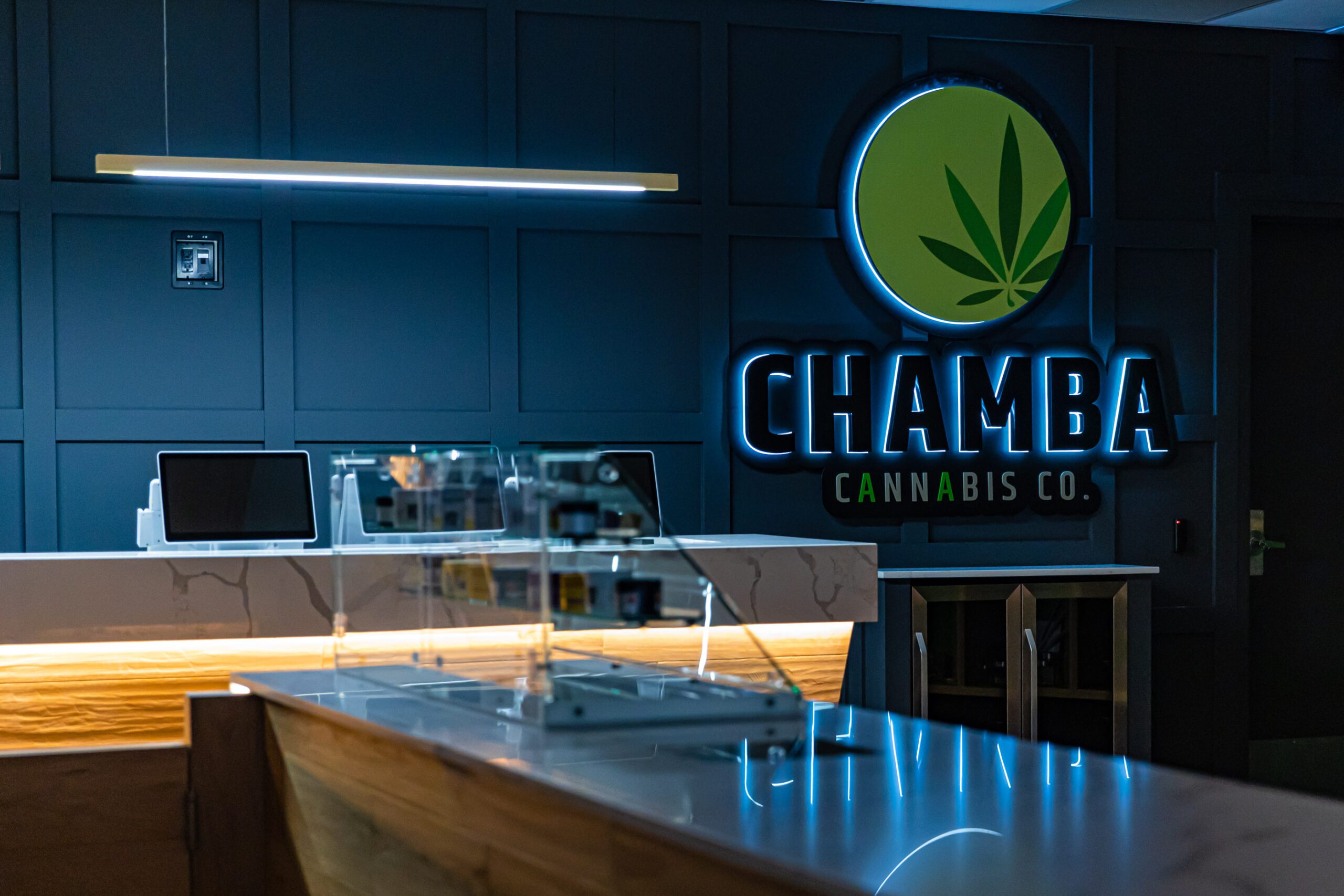 Chamba Cannabis Co. logo wall and counter display at Waterloo store.